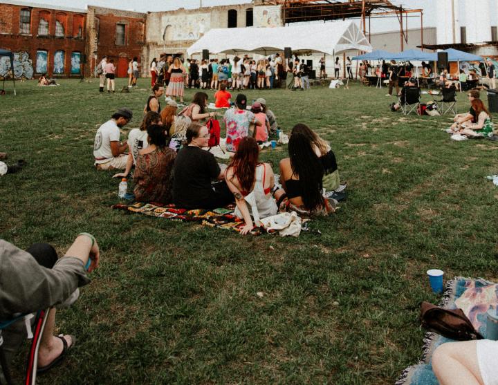 People sitting on the grass during a festival