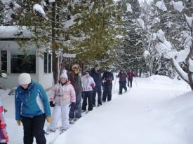 people starting off on a snowshoe looking happy to get out!