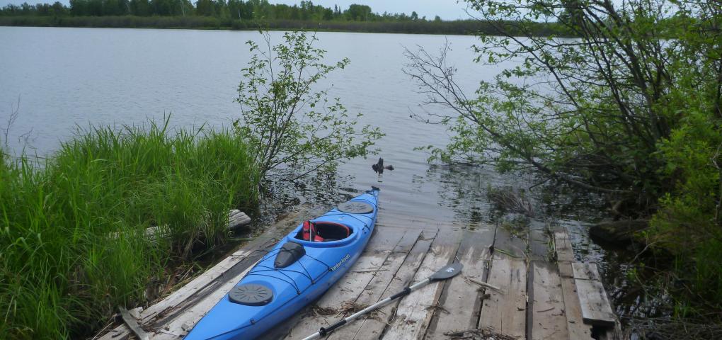 boat launch along shoreline with blue kayak 