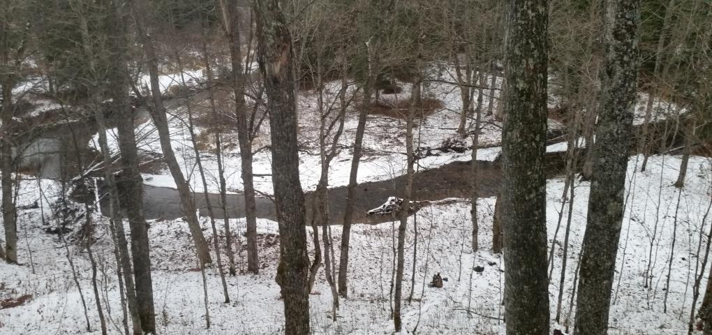 bend of river from steep bank view point in late fall with some snow